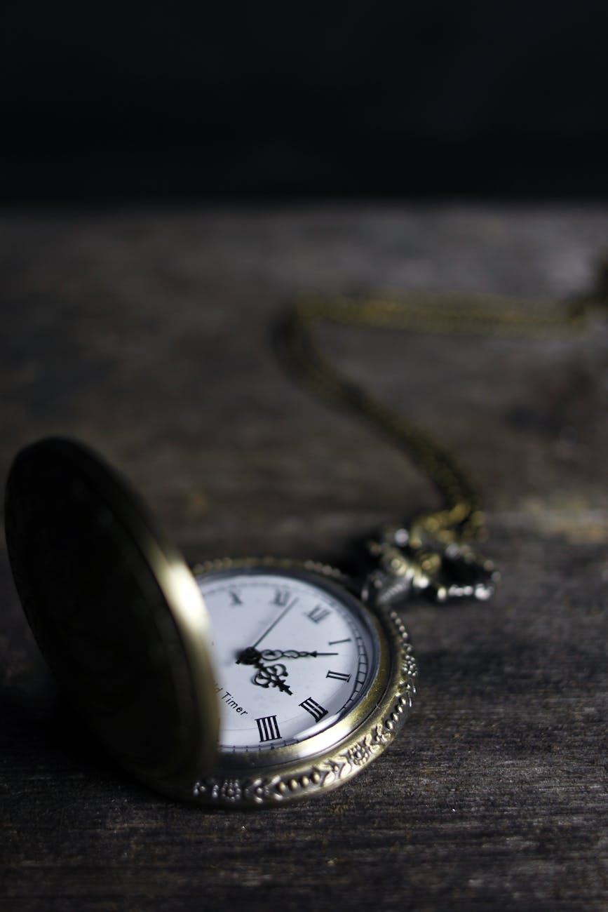 round silver colored pocket watch